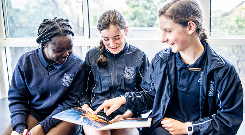 Three Our Lady of Lourdes Primary Seven Hills girls reading together