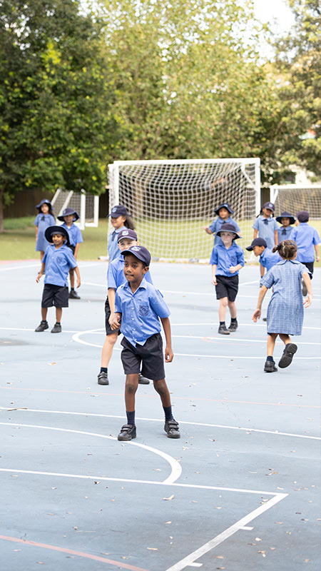 Our Lady of Lourdes Primary, Seven Hills students playing on outdoor soccer field